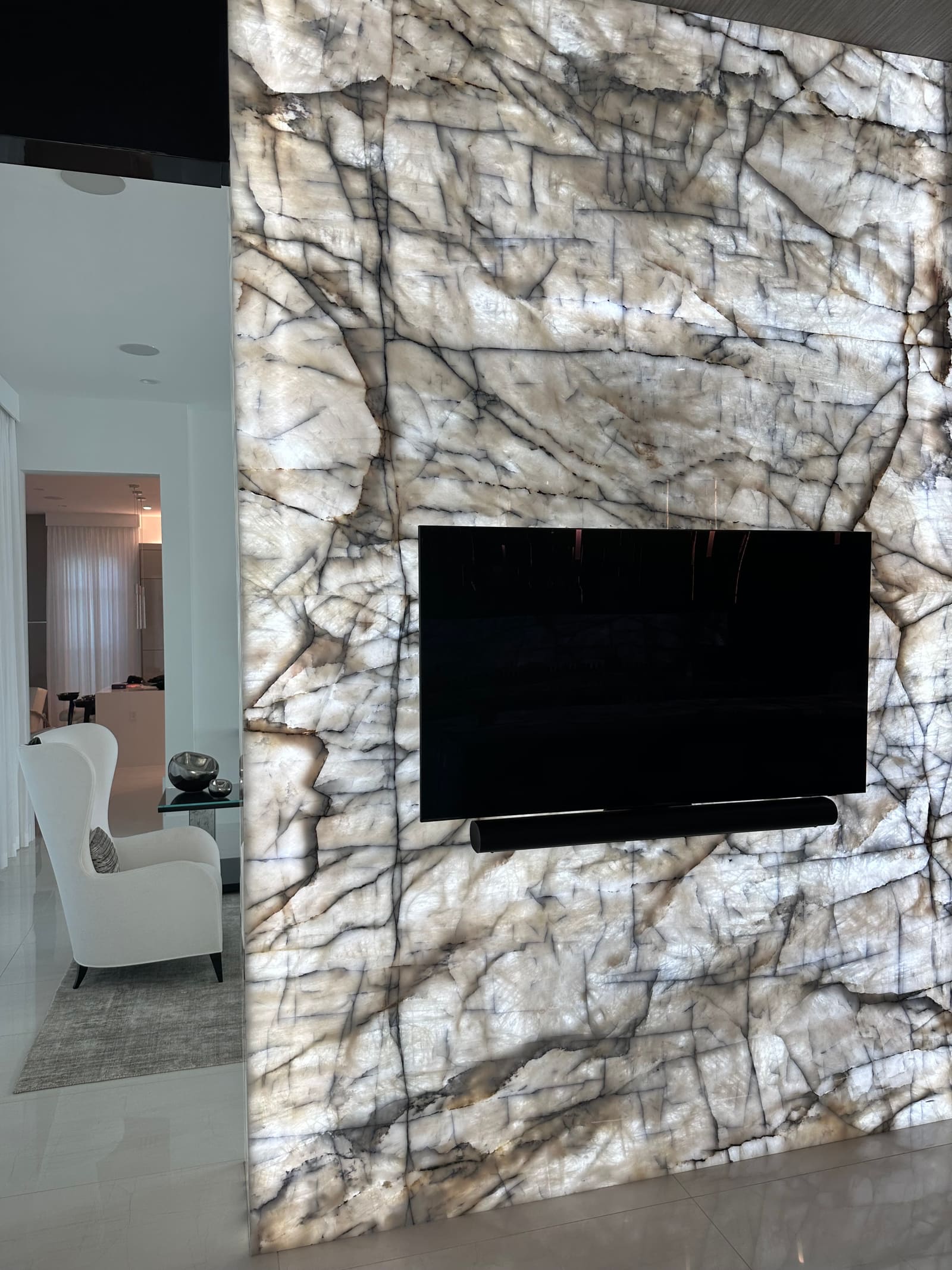 Backlit quartzite feature wall with recessed TV